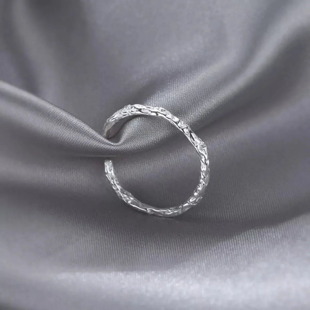 Woman wearing silver textured open ring