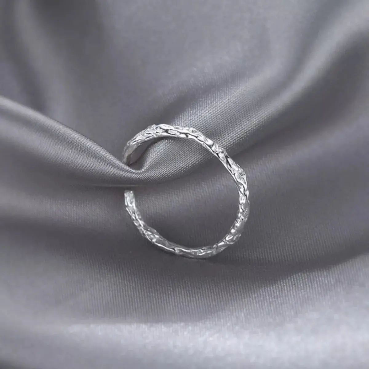 Woman wearing silver textured open ring