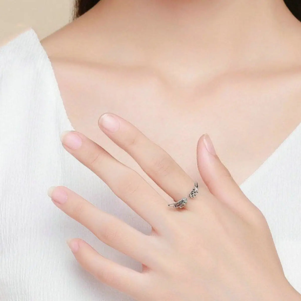 Woman wearing silver angel wing open ring