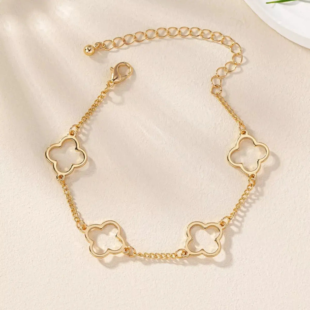 Woman wearing gold four leaf clover bracelet