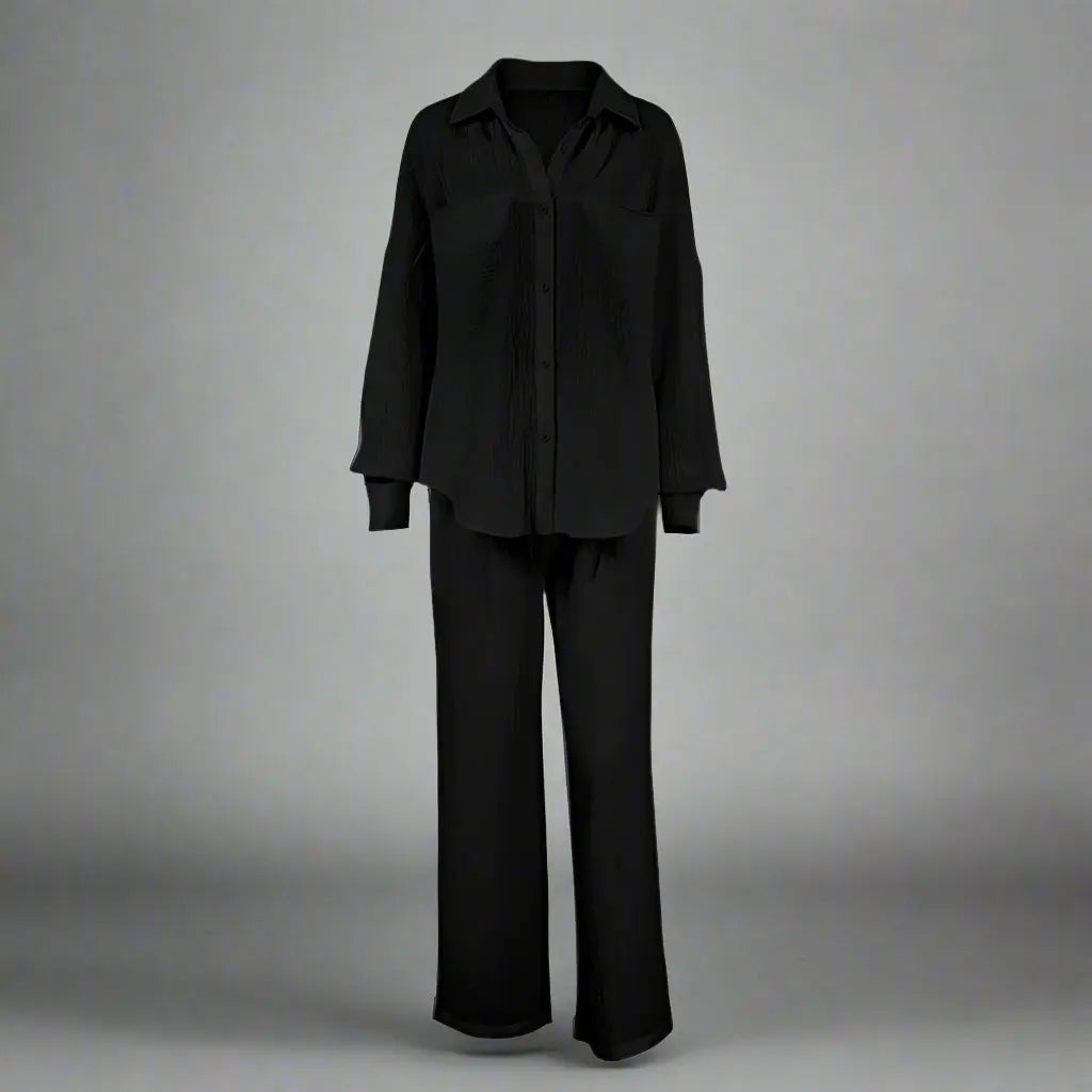 Black outfit with a shirt and pants on a gray background