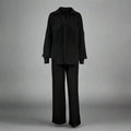 Black outfit with a shirt and pants on a gray background