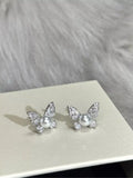 Butterfly pearl stud earrings from Vicsxox on display