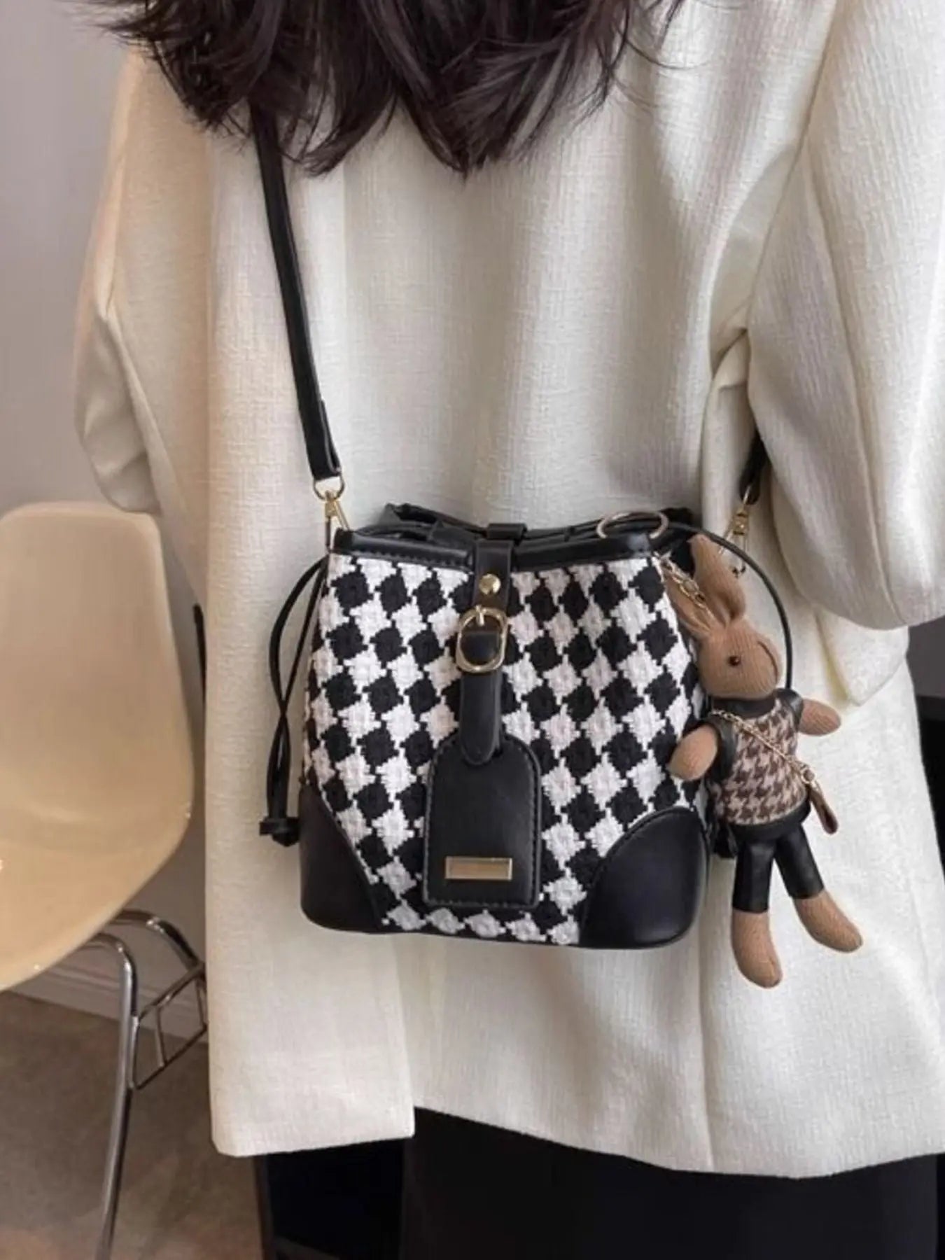 Checkerboard woven bucket crossbody bag styled on model Vicsxox.com