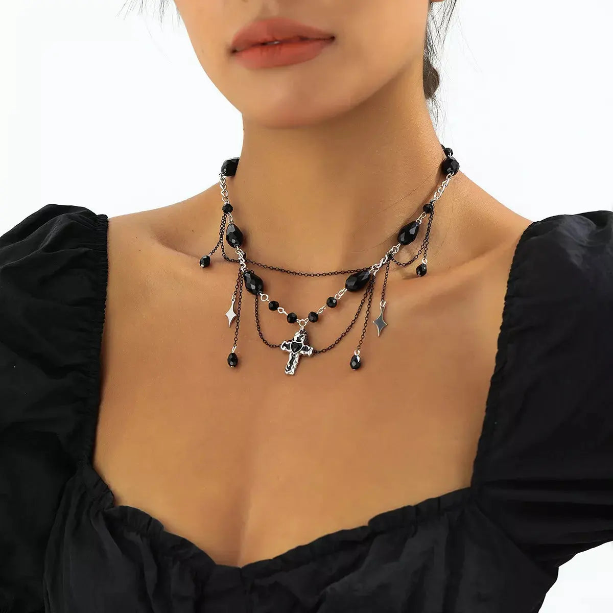 Woman wearing gothic cross pendant necklace