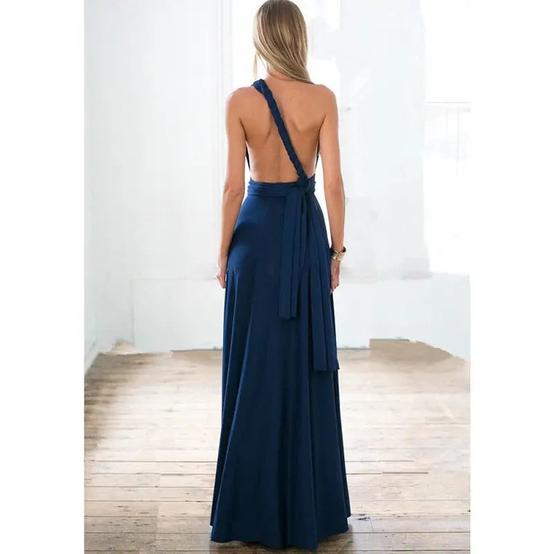 Woman wearing a navy blue one-shoulder dress with a white background