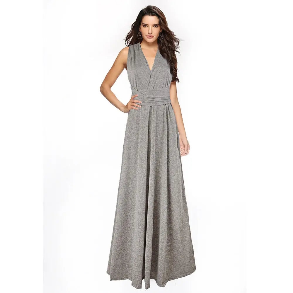 Woman wearing a gray maxi dress on a white background