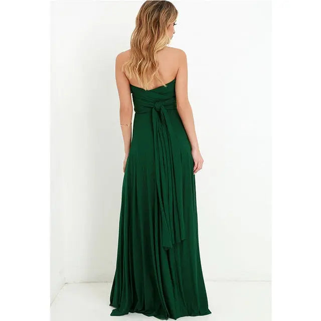 Woman wearing a green strapless gown against a white background