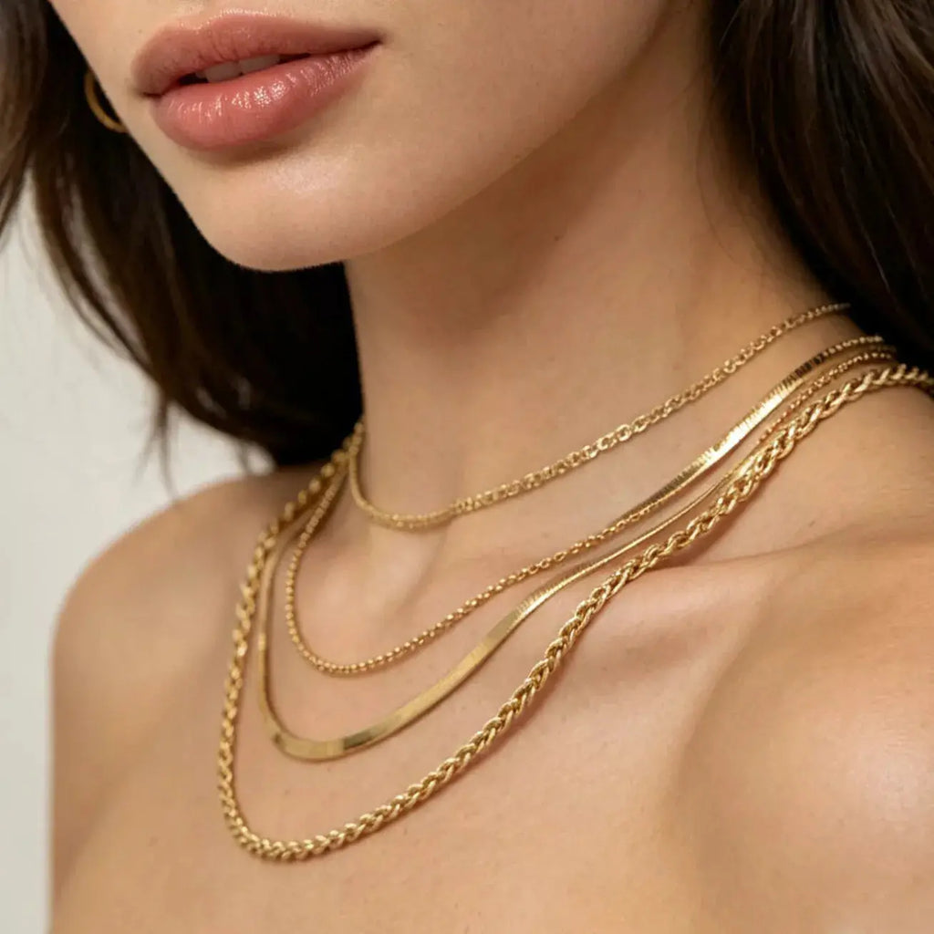 Woman wearing layered gold chain necklace