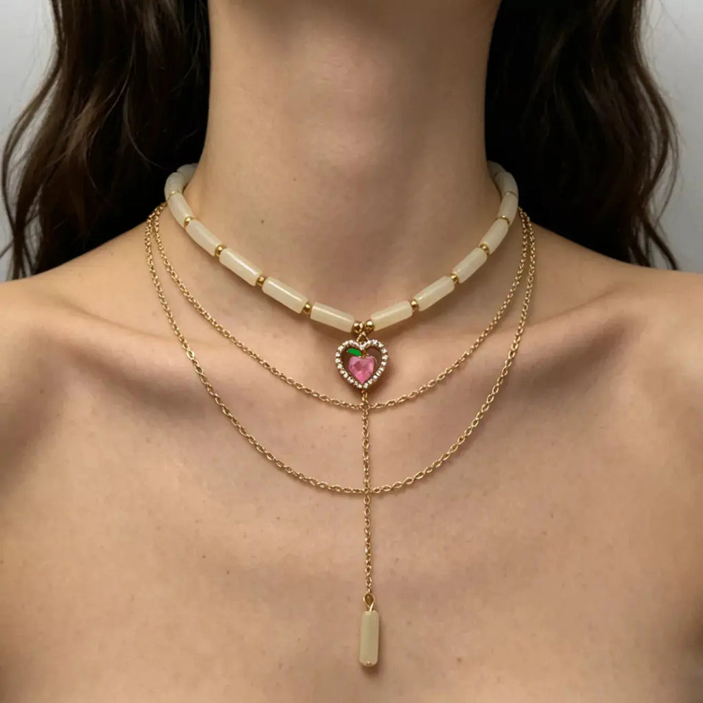Woman wearing layered heart pendant necklace