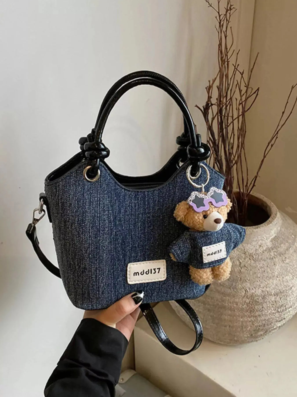 Mini denim top handle shoulder bag styled on model