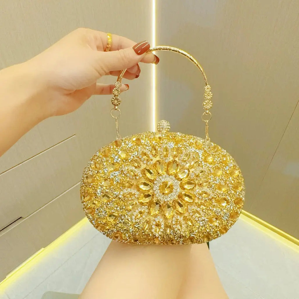 Gold beaded handbag held by a hand against a neutral background