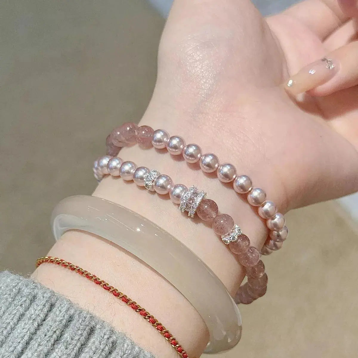 Woman wearing pearl beaded bracelet set