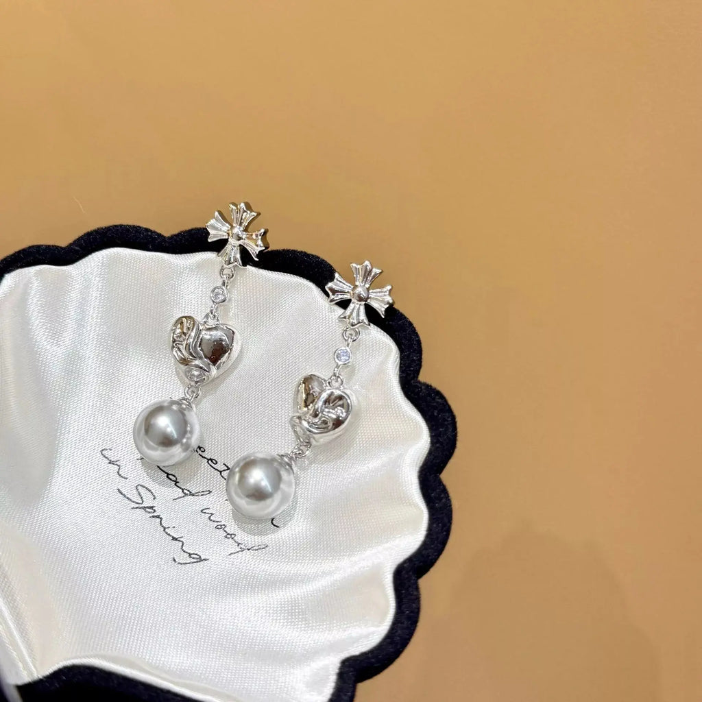 Pearl heart drop earrings from Vicsxox on display