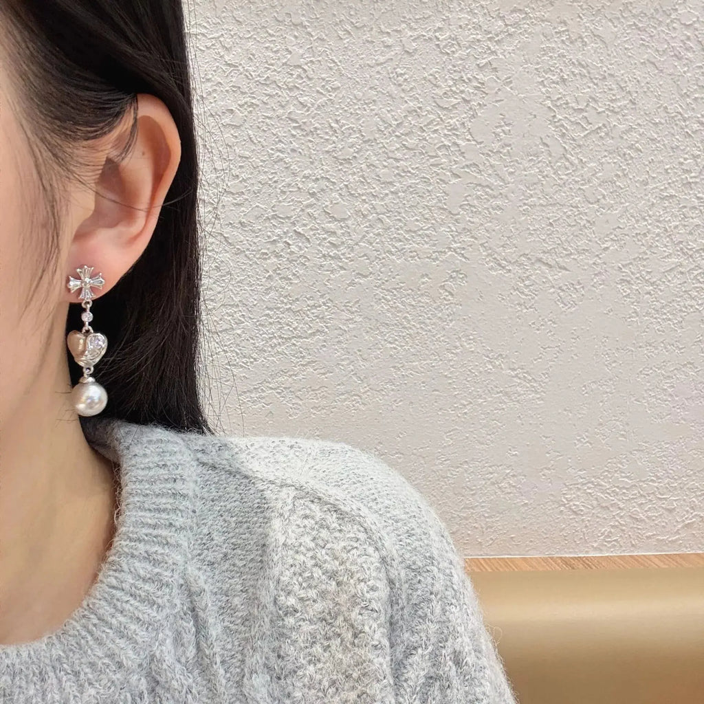 Close-up of pearl and zircon detail on heart drop earrings