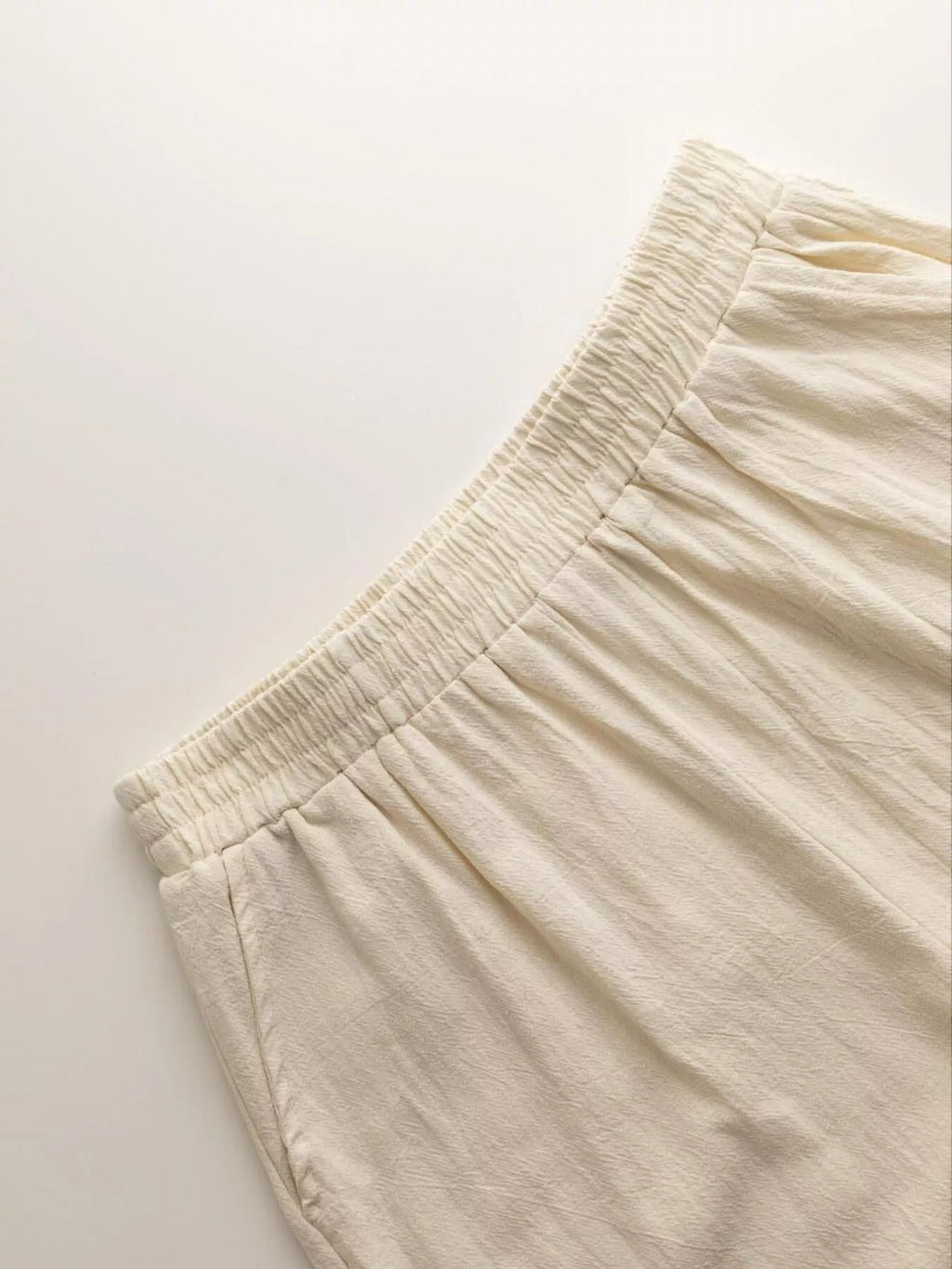Close-up of beige pants on a light background Vicsxox.com