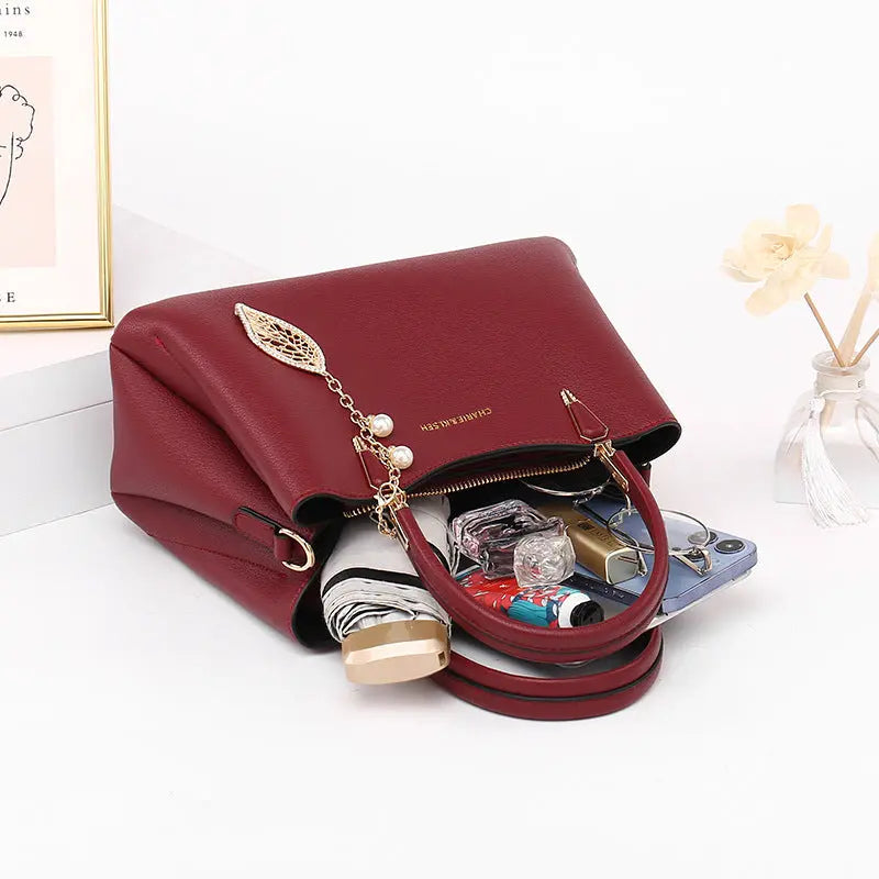 Structured vegan leather top-handle handbag with leaf charm, front view Vicsxox.com