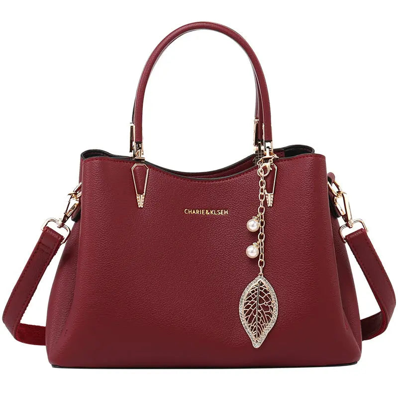Structured vegan leather top-handle handbag with leaf charm, front view Vicsxox.com