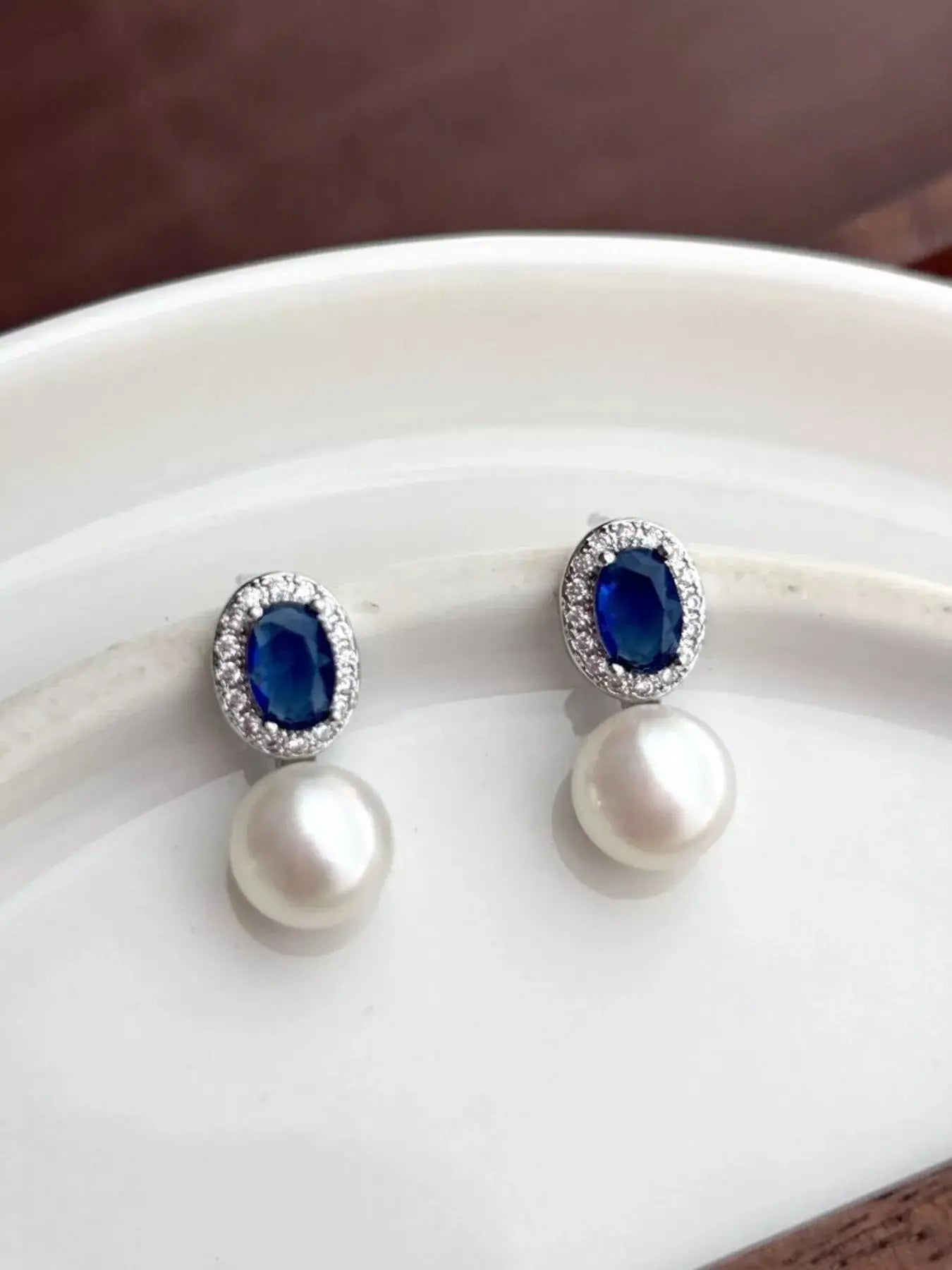 Pearl drop earrings from Vicsxox on display