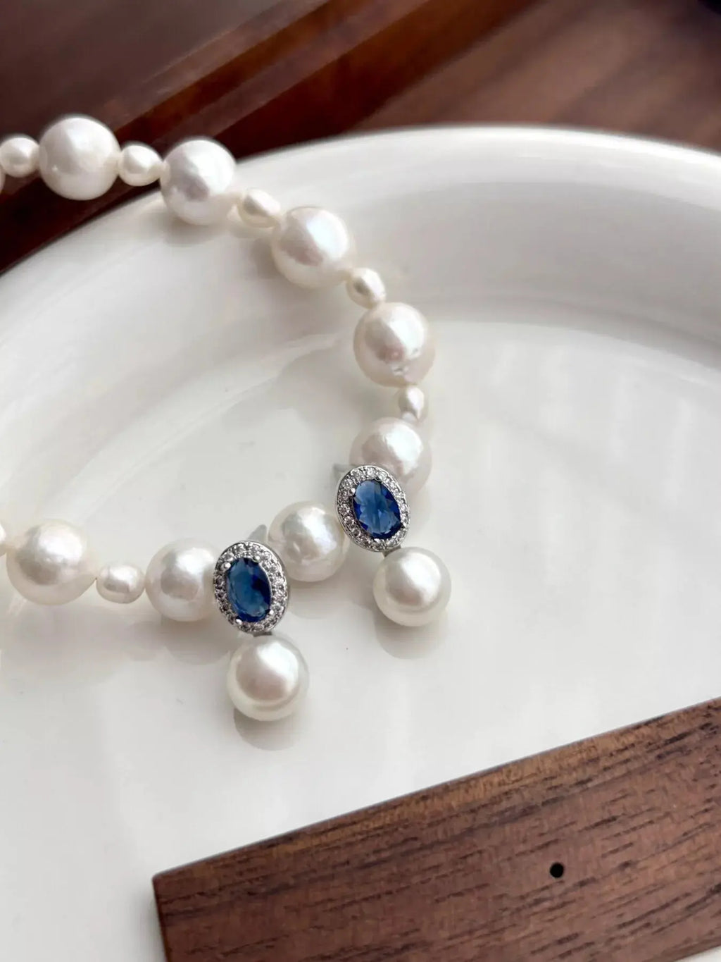 Woman wearing pearl drop earrings