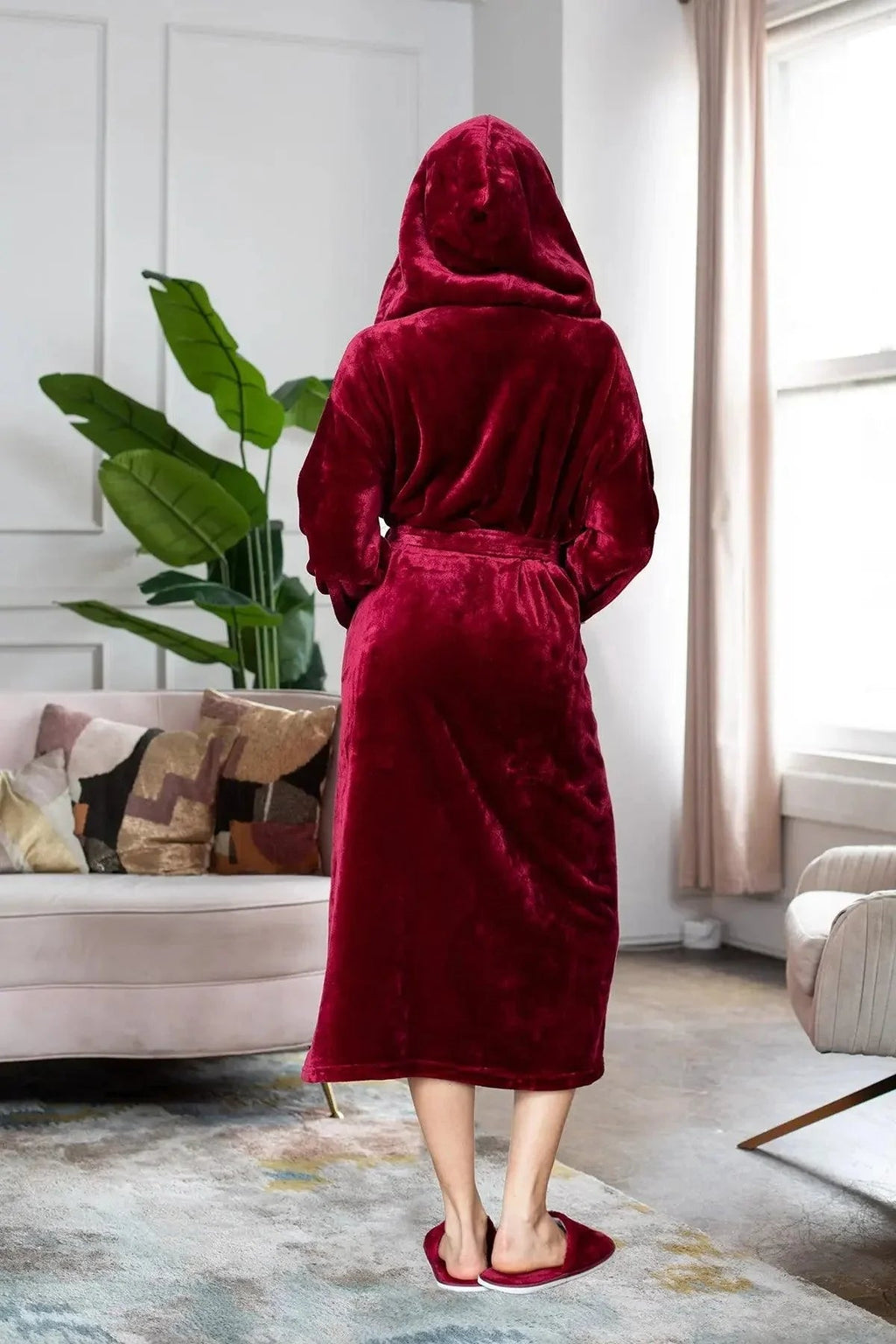 Person wearing a red robe standming in a living room. Vicsxox.com