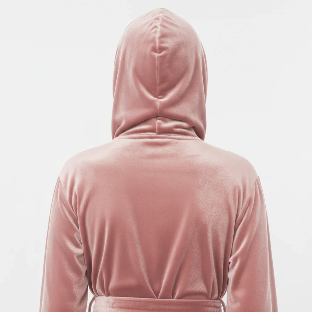 Person wearing a pink hooded garment on a light gray background Vicsxox.com