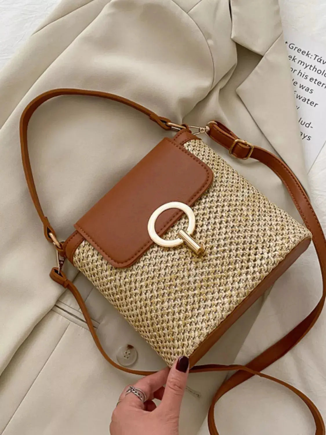 Woven straw crossbody bag with leather flap, front view Vicsxox.com