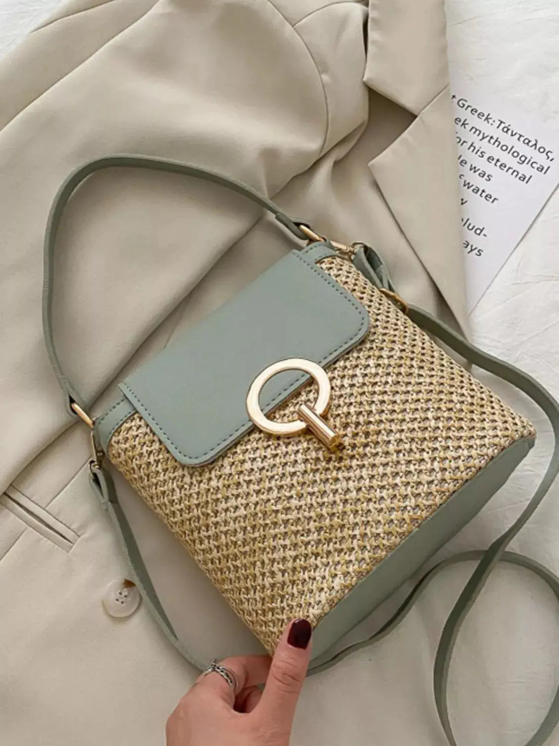 Woven straw crossbody bag with leather flap, front view Vicsxox.com 