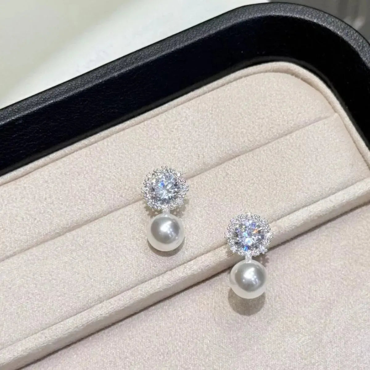 Close-up of zircon accent on pearl drop earrings