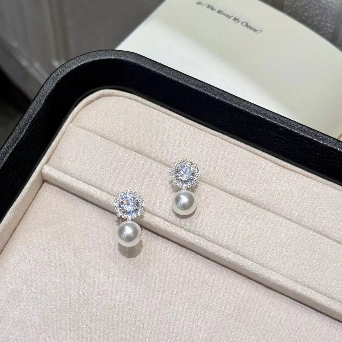 Woman wearing zircon pearl drop earrings