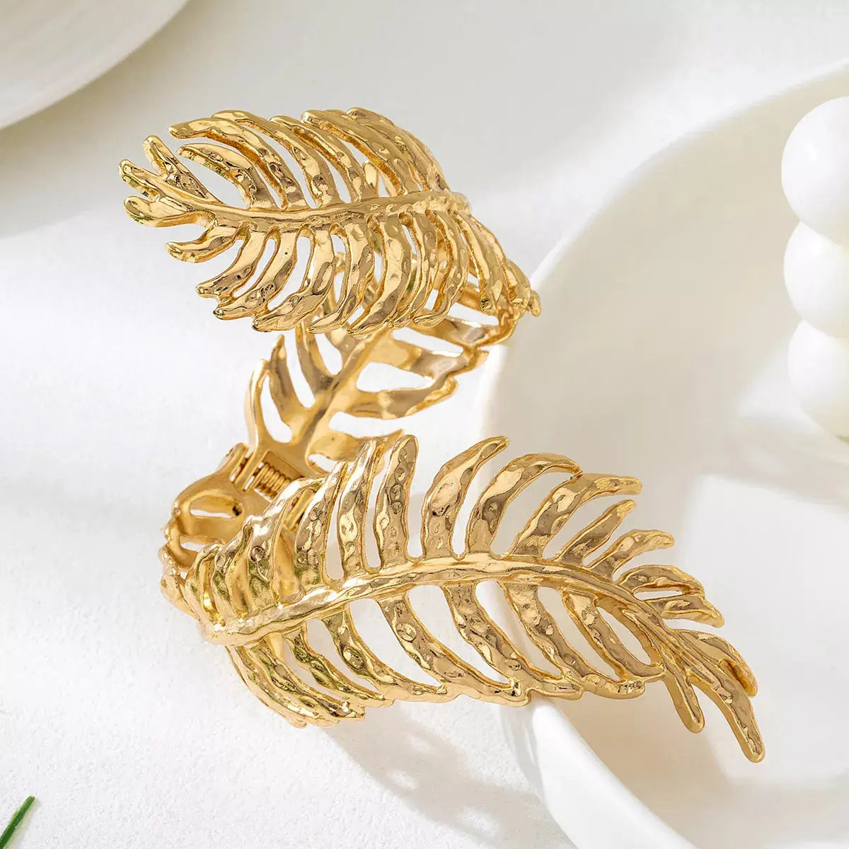 Close-up of leaf detail on gold bracelet