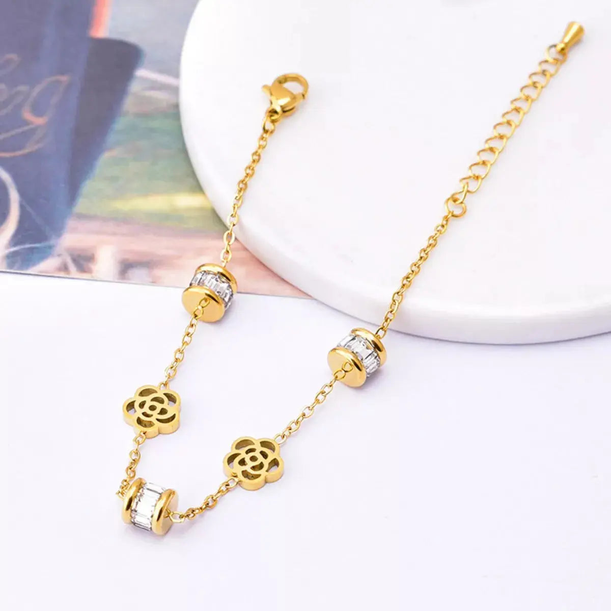 Close-up of flower and zircon detail on gold bracelet