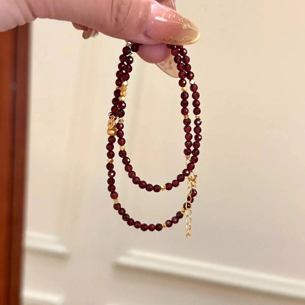 Close-up of garnet beads and gold accents on bracelet