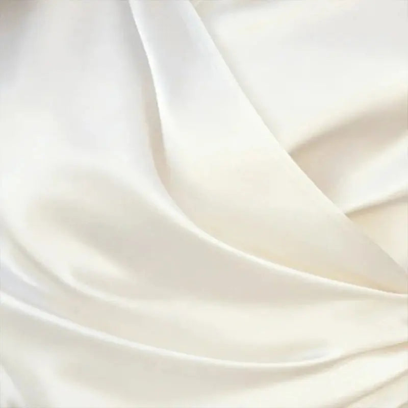 Close-up of smooth, white fabric with soft folds