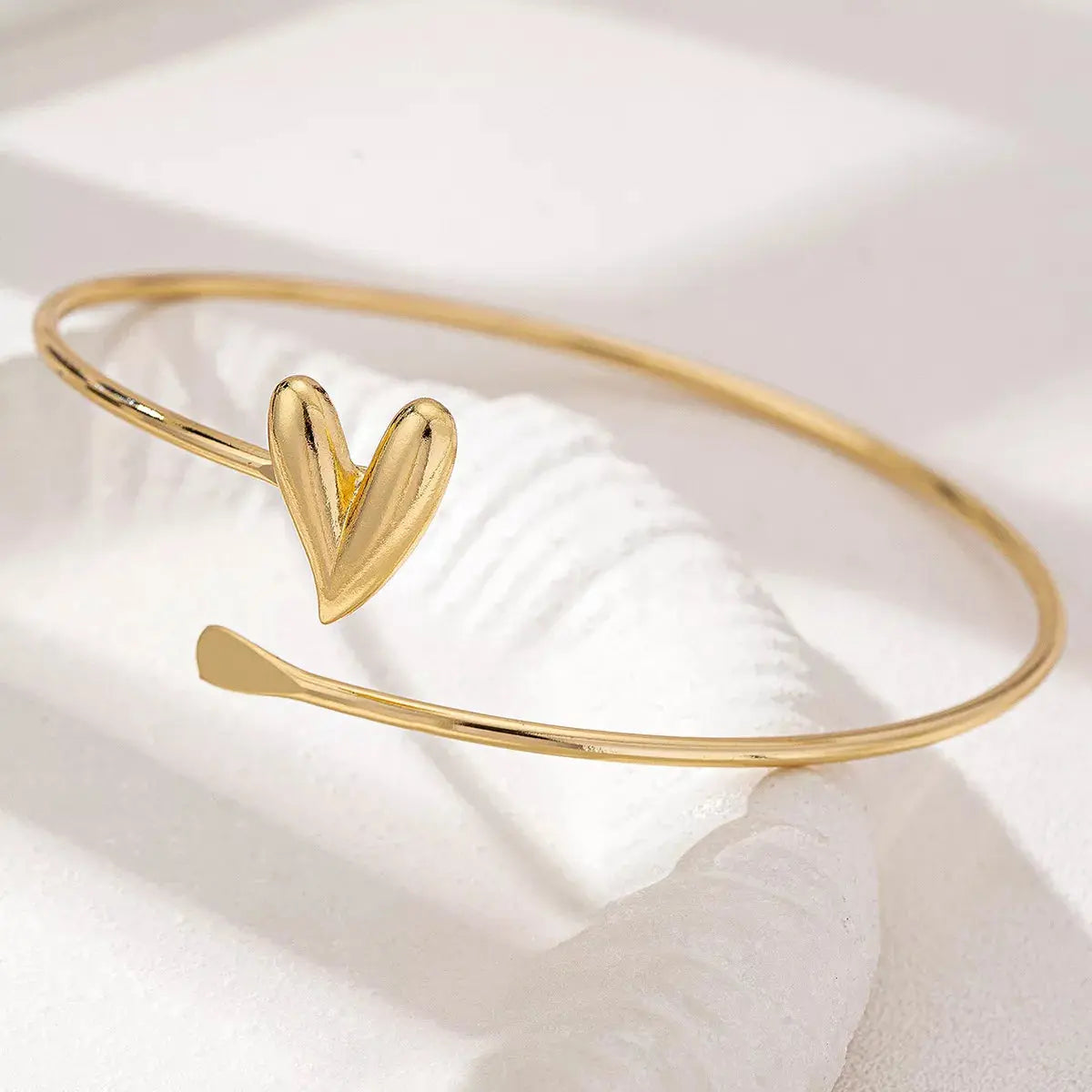 Woman wearing gold heart adjustable bracelet