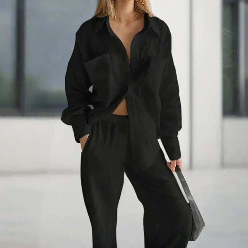Person wearing a black outfit with a blurred background