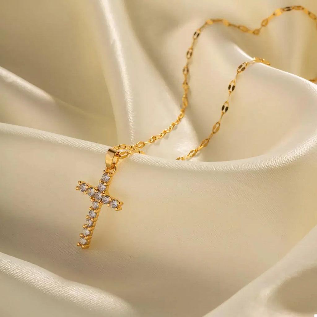 Woman wearing gold cross pendant necklace