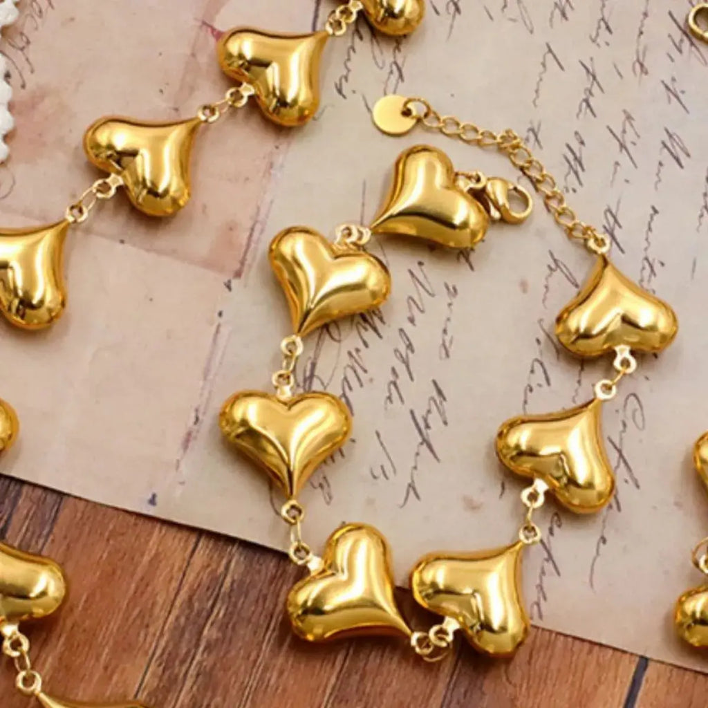 Close-up of heart charm on gold bracelet