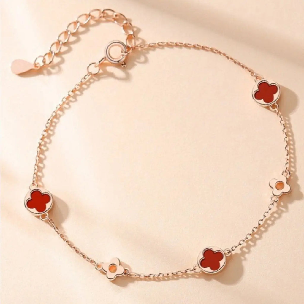 Close-up of rose gold clover charm with agate accent