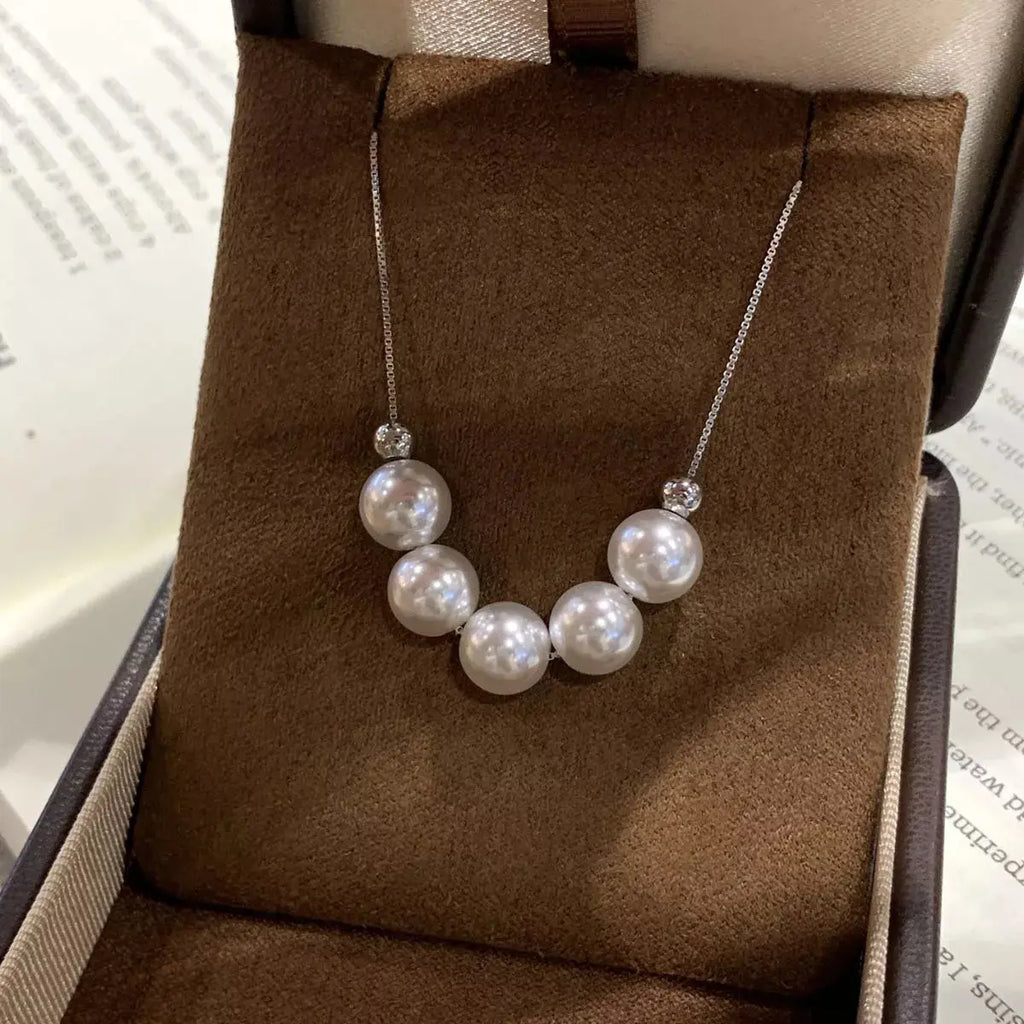 Woman wearing adjustable pearl necklace