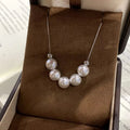 Woman wearing adjustable pearl necklace