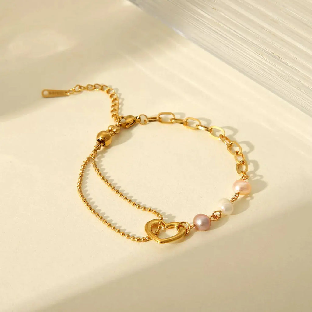Woman wearing gold heart pearl bracelet