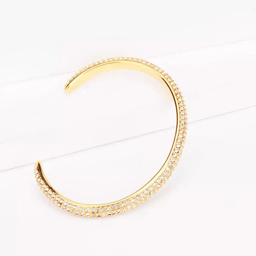 Close-up of zircon detail on gold copper bracelet