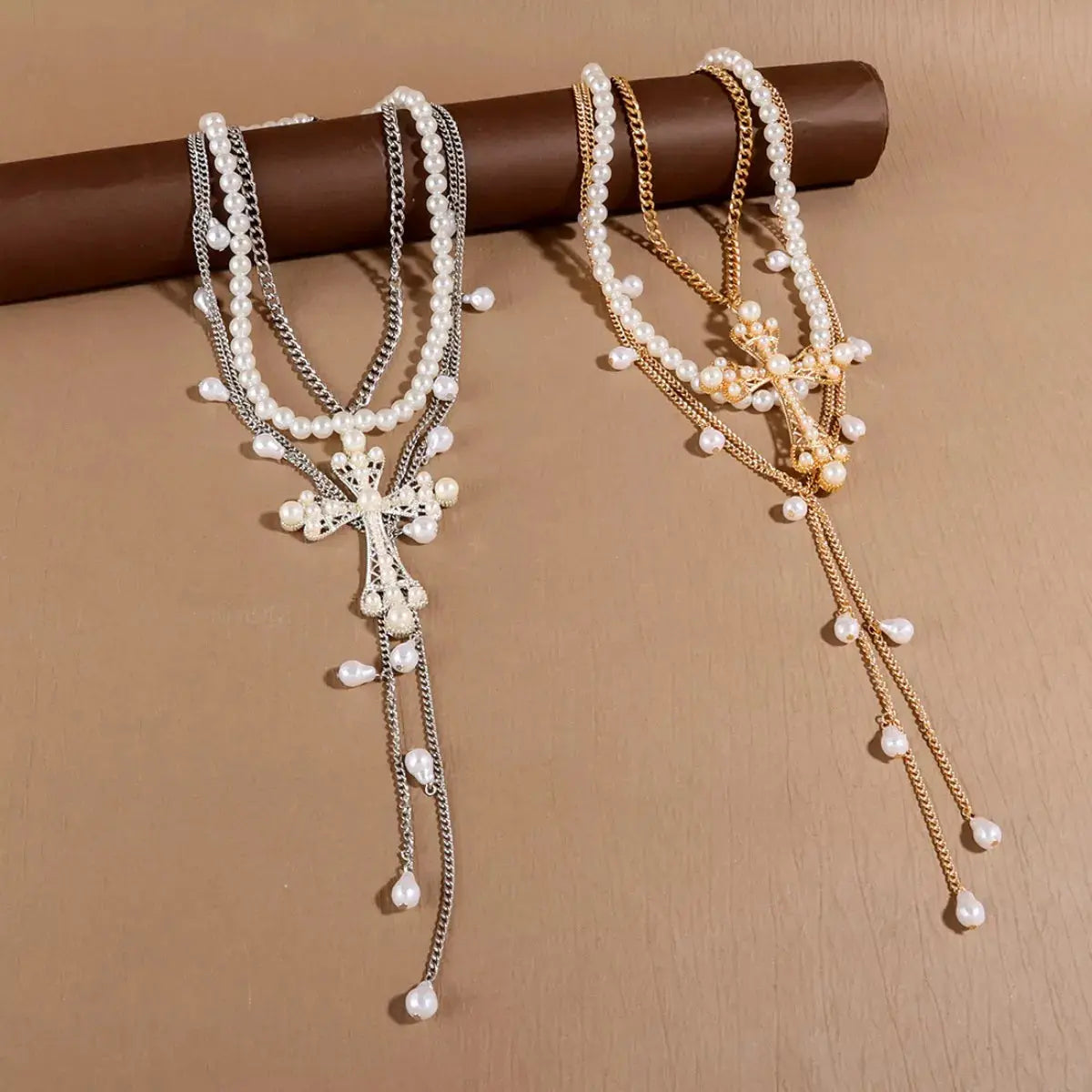Woman wearing layered pearl cross necklace set