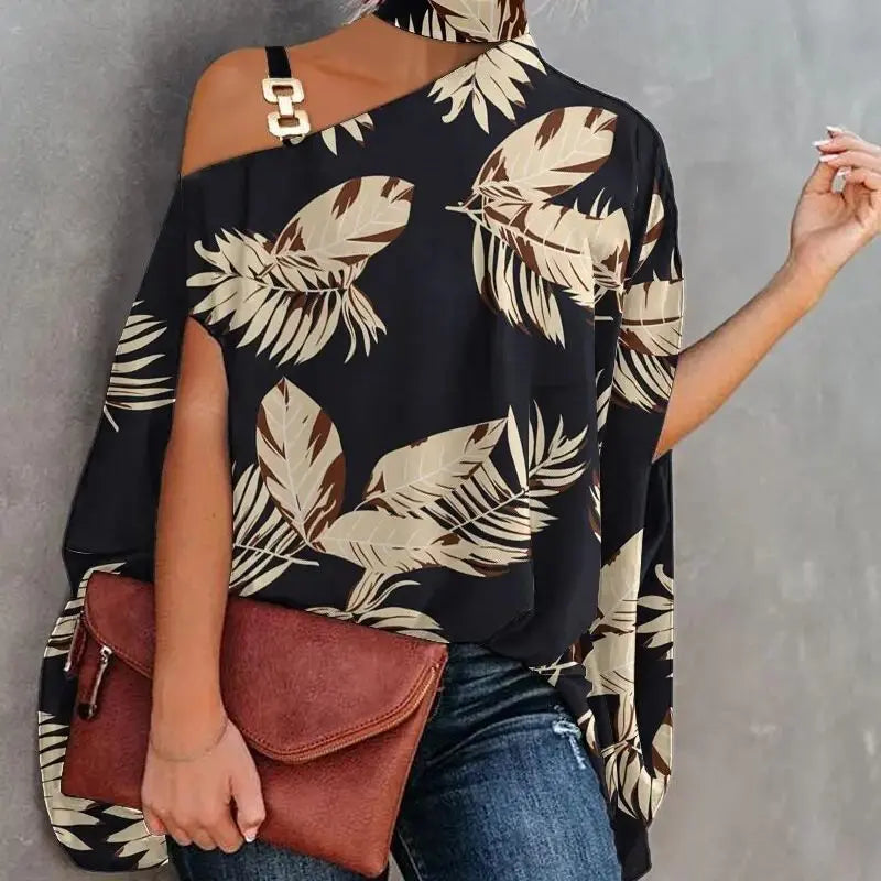 Woman wearing a black blouse with leaf pattern and holding a brown clutch against a gray background