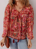 Woman wearing a paisley print tassel tie boho blouse from Vicsxox