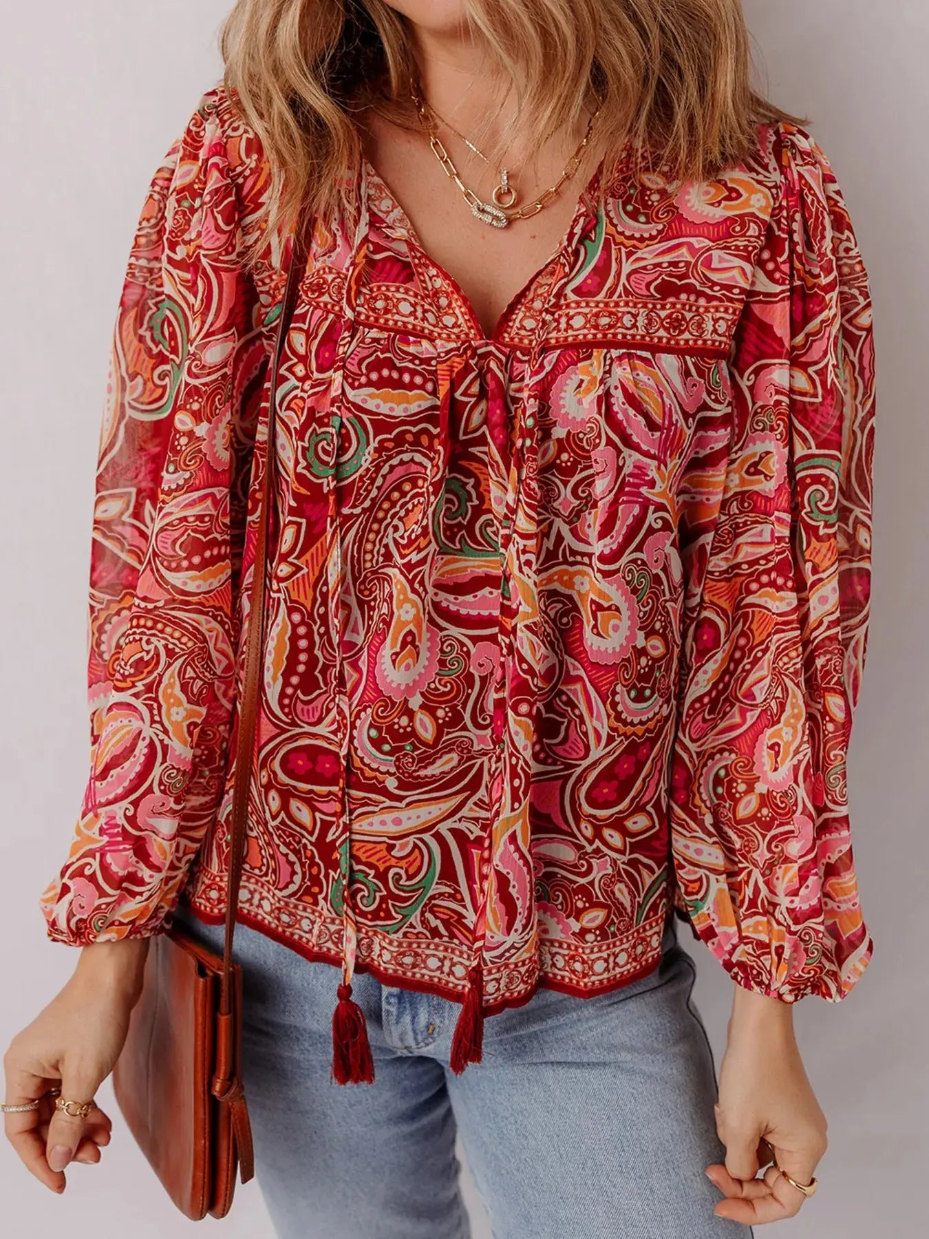 Woman wearing a paisley print tassel tie boho blouse from Vicsxox