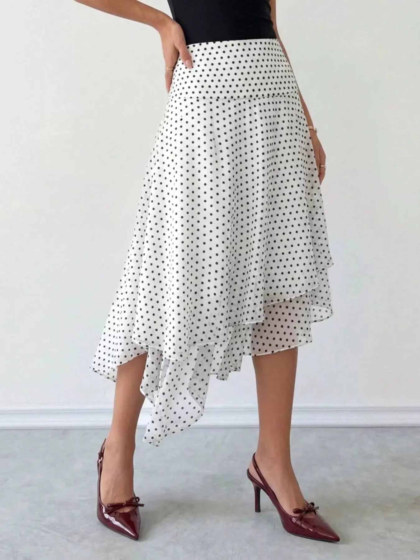 Polka dot asymmetrical midi skirt styled on model