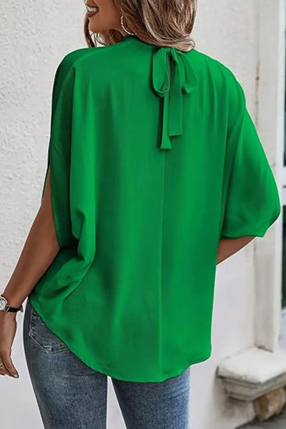 Back view of tied detail on half sleeve blouse