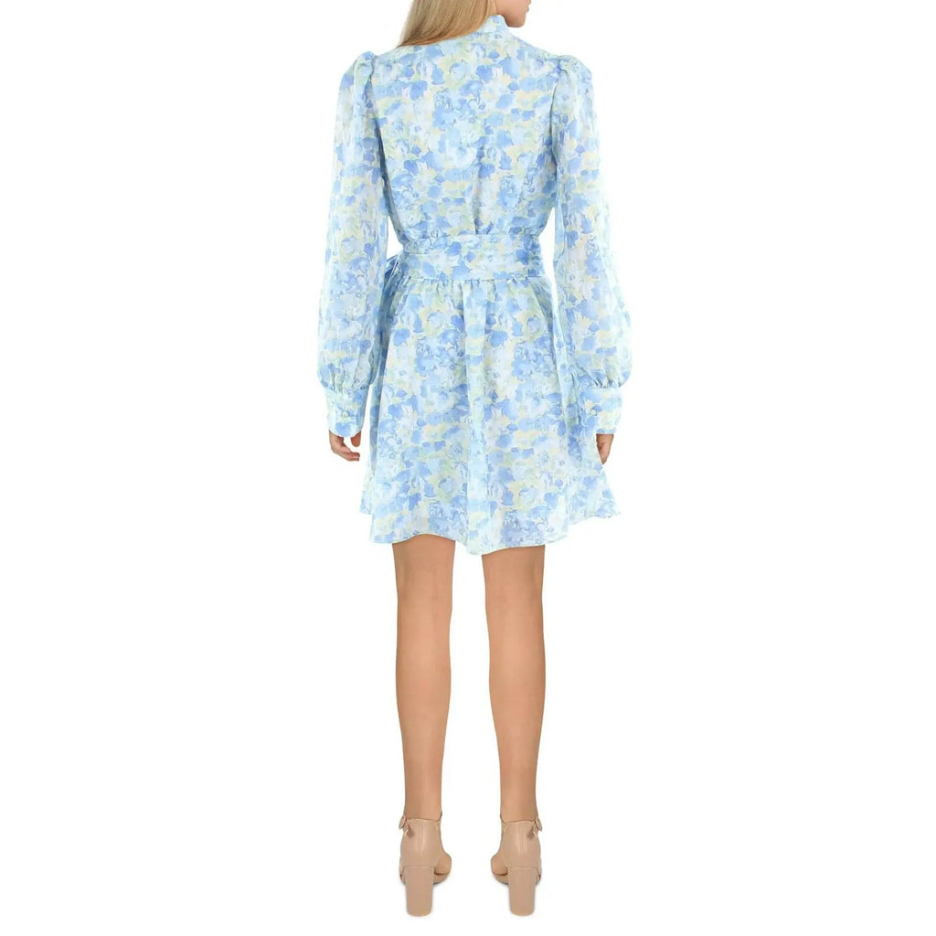 Woman wearing a light blue floral dress on a white background